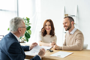 Couple speaking with an agent for auto insurance in Berkeley, CA